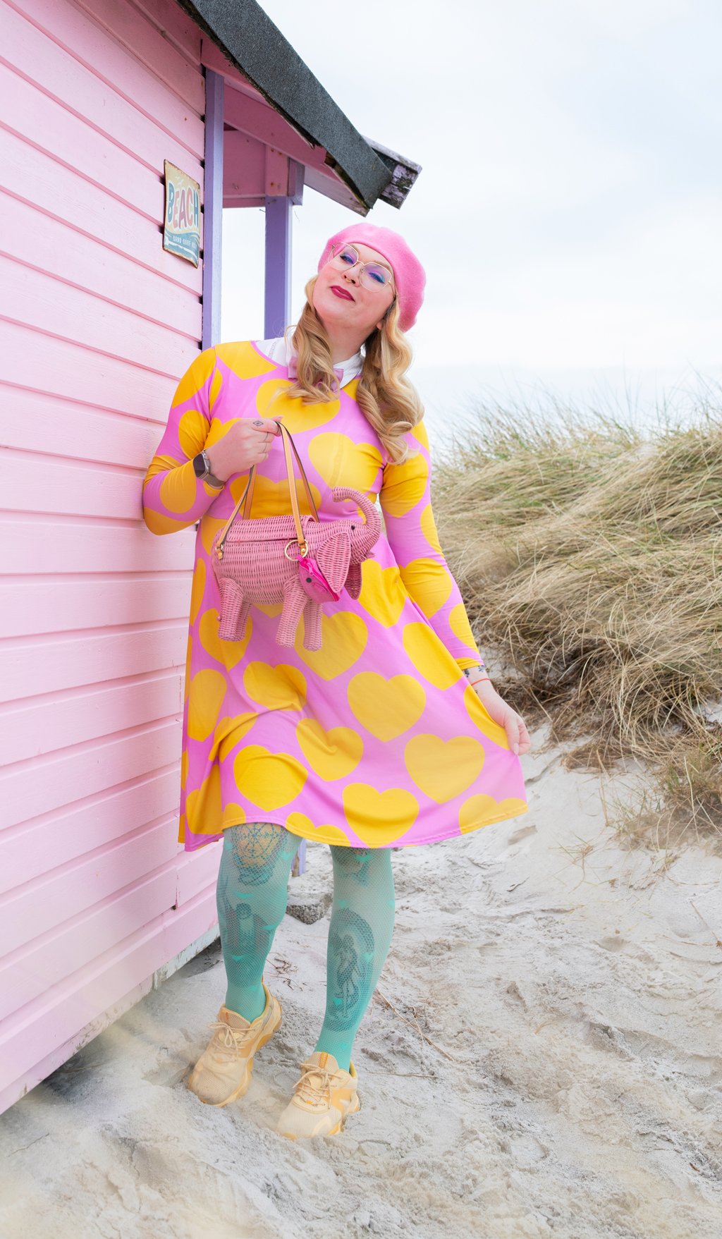 Woman in a colorful midi dress by SHALMIAK. Design: ELLIE LOVE yellow pink.