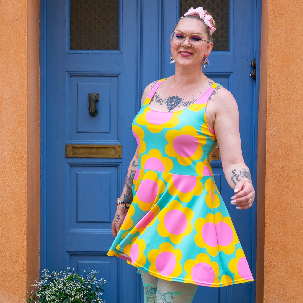 A woman in a colorful skater dress by SHALMIAK. Design: ELLIE.